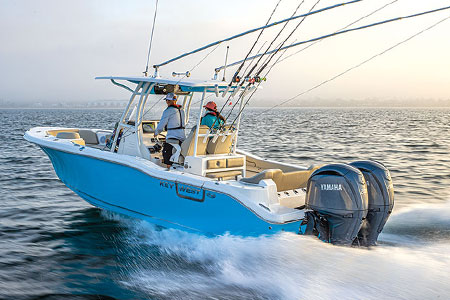 Two boaters cruising in their blue boat, powered by two Yamaha outboard engines.