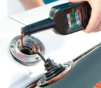 A boat owner adding Yamalube Fuel Stabilizer to the boat.