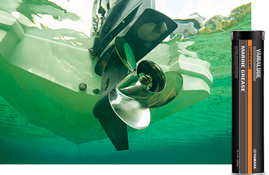 A boat propeller under water with Yamalube Marine Grease in the foreground.
